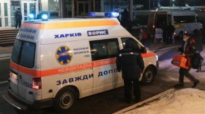 Airport employee stands near an ambulance, which is believed to be transporting Ukrainian activist Dmytro Bulatov, at Borispol airport